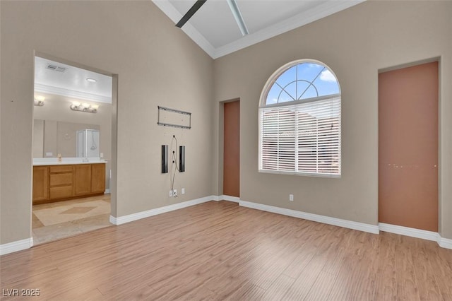 9975 Sand Key St, Las Vegas, NV 89178 - unfurnished bedroom featuring crown molding, light wood-type flooring, ensuite bathroom, and a high ceiling
