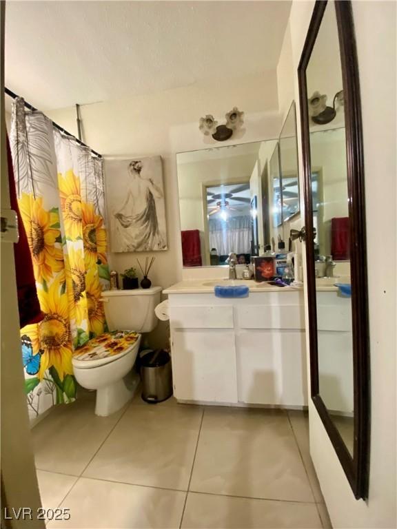 1748 Jupiter Ct Unit C, Las Vegas, NV 89119 - bathroom featuring toilet, tile patterned floors, vanity, and curtained shower