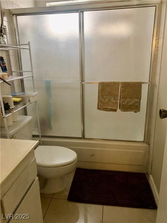 1748 Jupiter Ct Unit C, Las Vegas, NV 89119 - full bathroom featuring combined bath / shower with glass door, tile patterned floors, toilet, and vanity