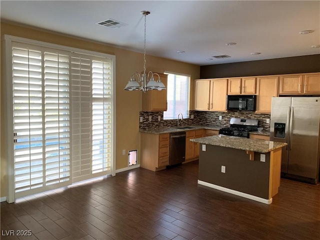 533 Via Santiago St, Las Vegas, NV 89144 - kitchen featuring stainless steel appliances, a chandelier, a sink, decorative backsplash, and a kitchen island