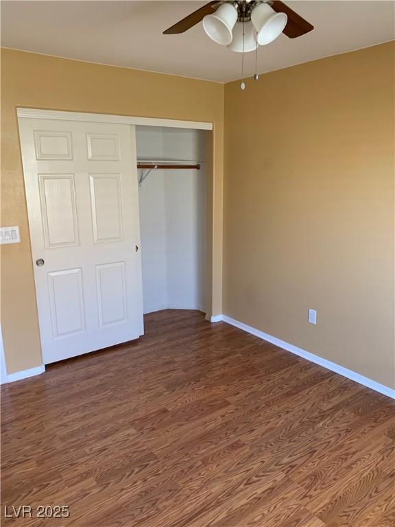 533 Via Santiago St, Las Vegas, NV 89144 - unfurnished bedroom featuring wood finished floors, a closet, baseboards, and ceiling fan