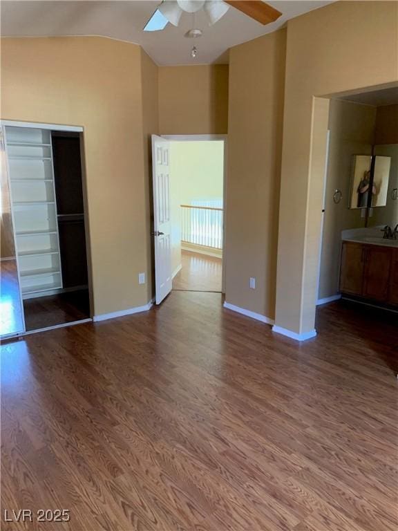 533 Via Santiago St, Las Vegas, NV 89144 - unfurnished bedroom with wood finished floors, baseboards, a sink, a closet, and vaulted ceiling