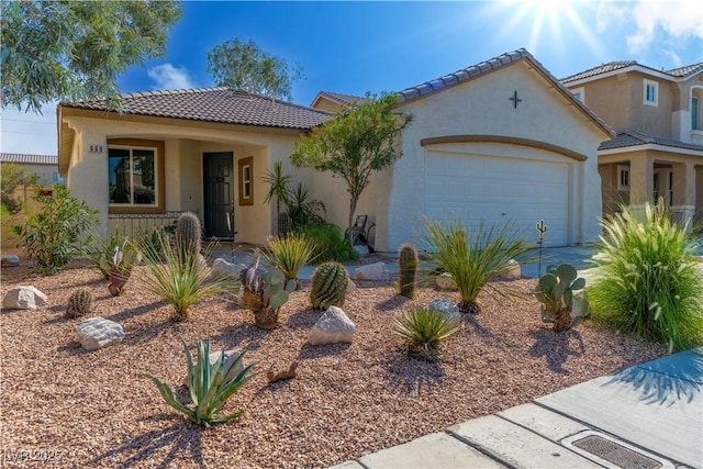 669 Elliot Peak Ave, Las Vegas, NV 89183 - mediterranean / spanish-style home featuring stucco siding, a tile roof, an attached garage, covered porch, and concrete driveway