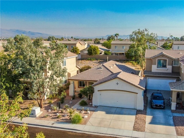 669 Elliot Peak Ave, Las Vegas, NV 89183 - mediterranean / spanish-style house with stucco siding, a residential view, a tile roof, driveway, and a garage