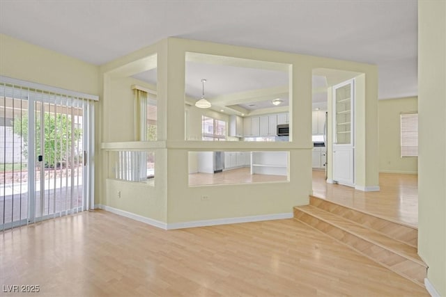 9746 Driftwood Island Ct, Las Vegas, NV 89148 - unfurnished living room featuring light wood finished floors, baseboards, and ceiling fan