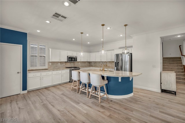 5553 Coral Gate St, Las Vegas, NV 89148 - kitchen with stainless steel appliances, ornamental molding, white cabinets, backsplash, and a sink