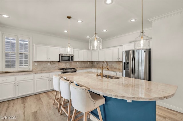 5553 Coral Gate St, Las Vegas, NV 89148 - kitchen with stainless steel appliances, a sink, white cabinets, crown molding, and decorative backsplash