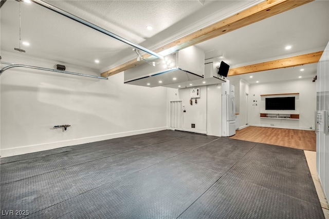 5553 Coral Gate St, Las Vegas, NV 89148 - garage featuring recessed lighting, freestanding refrigerator, and baseboards
