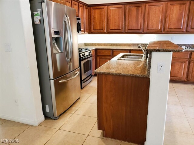 8550 Bright Bush St, Las Vegas, NV 89131 - kitchen with stainless steel appliances, an island with sink, and light tile patterned floors