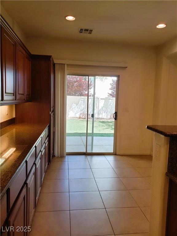 8550 Bright Bush St, Las Vegas, NV 89131 - kitchen with recessed lighting, dark stone counters, and light tile patterned flooring