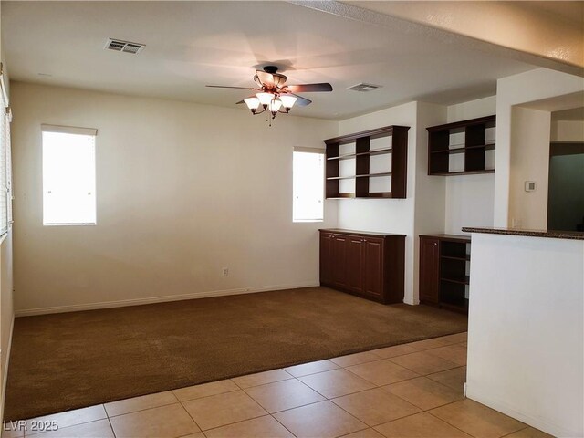 8550 Bright Bush St, Las Vegas, NV 89131 - empty room with light carpet, light tile patterned floors, ceiling fan, and baseboards