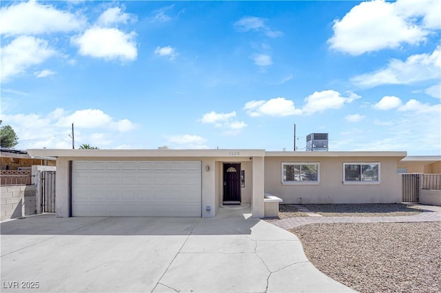 1628 Patricia St, North Las Vegas, NV 89030 - ranch-style home with stucco siding, concrete driveway, central AC, and a garage