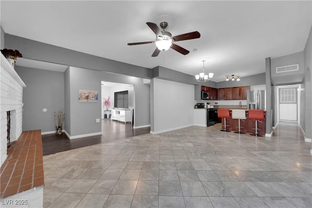 1628 Patricia St, North Las Vegas, NV 89030 - living area featuring ceiling fan, a chandelier, a fireplace, and baseboards
