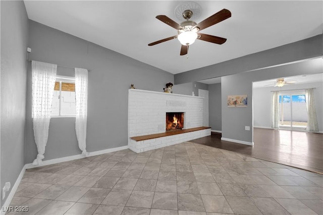 1628 Patricia St, North Las Vegas, NV 89030 - unfurnished living room with a ceiling fan, vaulted ceiling, a brick fireplace, baseboards, and tile patterned floors