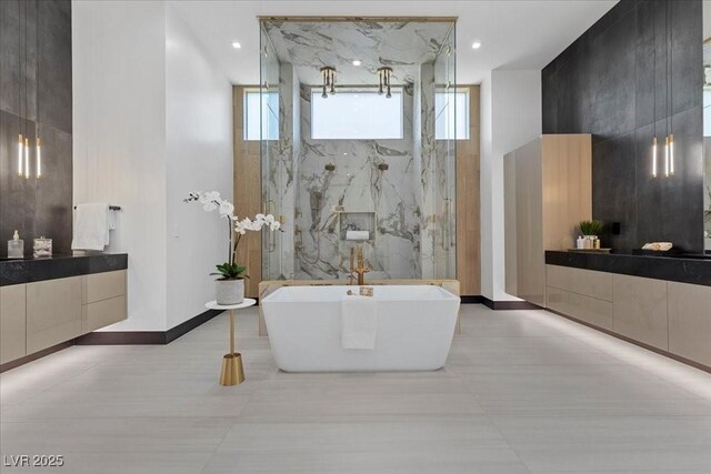 38 Skybird Ct, Las Vegas, NV 89135 - full bath featuring a freestanding tub, vanity, baseboards, recessed lighting, and a marble finish shower