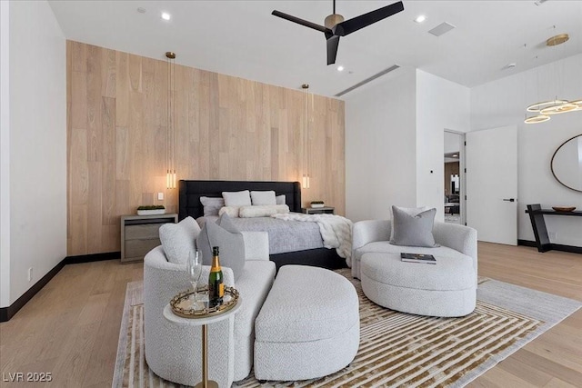 38 Skybird Ct, Las Vegas, NV 89135 - bedroom featuring wood walls, light wood-style floors, baseboards, ceiling fan, and a towering ceiling