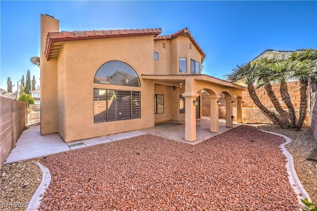 8932 Beach Front Dr, Las Vegas, NV 89117 - rear view of house featuring stucco siding, a patio area, and a fenced backyard