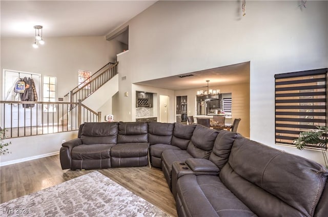 8932 Beach Front Dr, Las Vegas, NV 89117 - living area featuring a chandelier, high vaulted ceiling, wood finished floors, and stairs