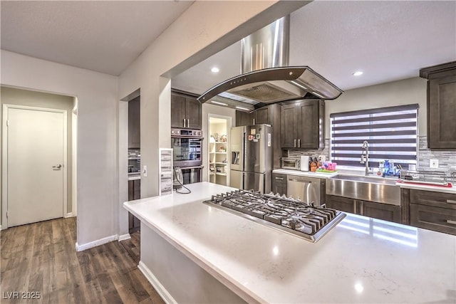 8932 Beach Front Dr, Las Vegas, NV 89117 - kitchen featuring stainless steel appliances, a sink, dark brown cabinets, light countertops, and recessed lighting
