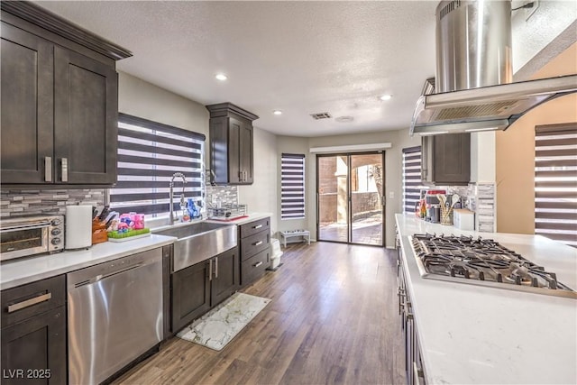 8932 Beach Front Dr, Las Vegas, NV 89117 - kitchen with appliances with stainless steel finishes, a sink, island range hood, light countertops, and recessed lighting