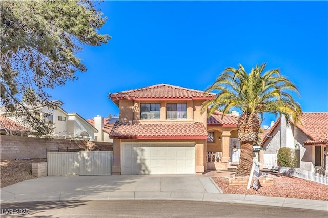 8932 Beach Front Dr, Las Vegas, NV 89117 - mediterranean / spanish-style home with a tile roof, stucco siding, an attached garage, and concrete driveway
