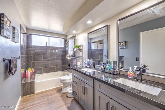 8932 Beach Front Dr, Las Vegas, NV 89117 - full bathroom featuring toilet, double vanity, shower / tub combo, wood finished floors, and recessed lighting