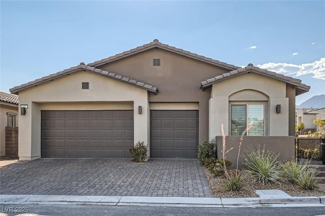 157 Sarabeth St, Las Vegas, NV 89138 - view of front of house with stucco siding, a tile roof, a garage, and decorative driveway