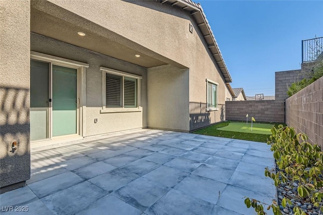 157 Sarabeth St, Las Vegas, NV 89138 - fenced backyard with a putting green and a patio