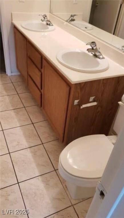 3644 Starlight Evening St, Las Vegas, NV 89129 - bathroom with double vanity, toilet, and tile patterned flooring