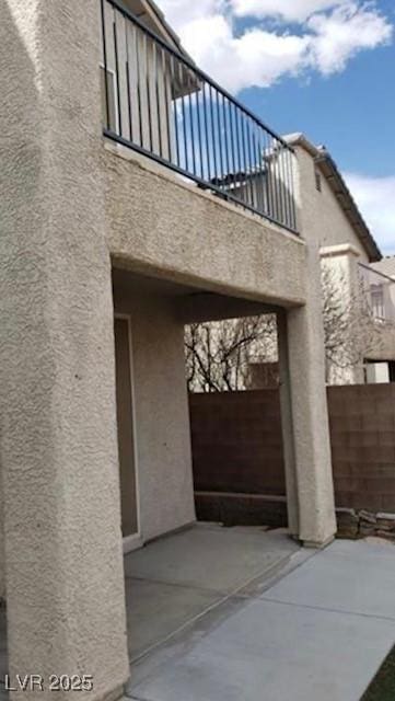 3644 Starlight Evening St, Las Vegas, NV 89129 - view of side of property featuring a balcony, stucco siding, and a patio
