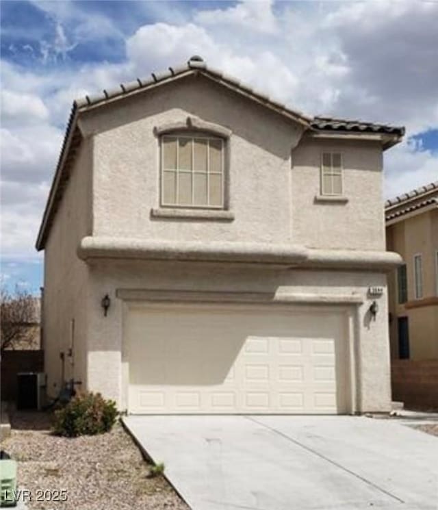3644 Starlight Evening St, Las Vegas, NV 89129 - view of front facade featuring an attached garage, stucco siding, concrete driveway, and a tiled roof