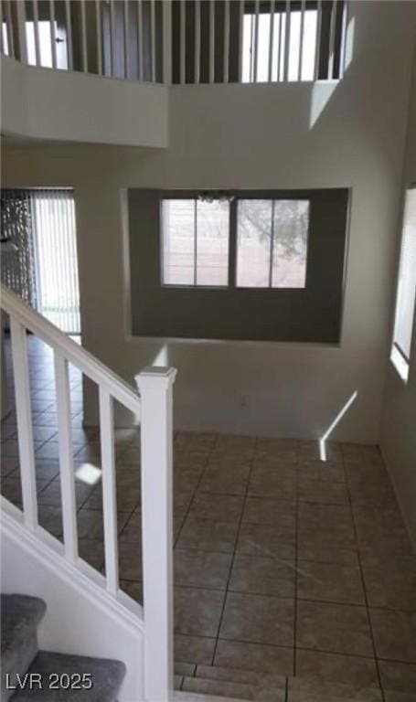 3644 Starlight Evening St, Las Vegas, NV 89129 - stairs with a high ceiling, healthy amount of natural light, and tile patterned floors