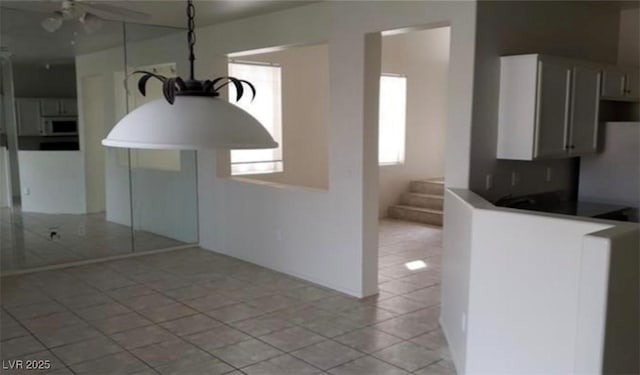 3644 Starlight Evening St, Las Vegas, NV 89129 - kitchen featuring white microwave, light tile patterned floors, and a ceiling fan