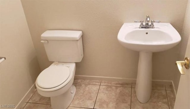 3644 Starlight Evening St, Las Vegas, NV 89129 - bathroom with toilet, a sink, baseboards, and tile patterned flooring