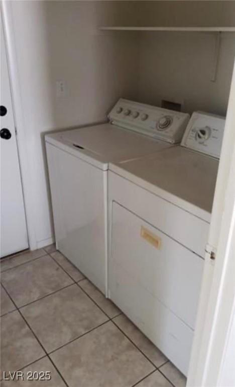 3644 Starlight Evening St, Las Vegas, NV 89129 - washroom with separate washer and dryer and light tile patterned floors