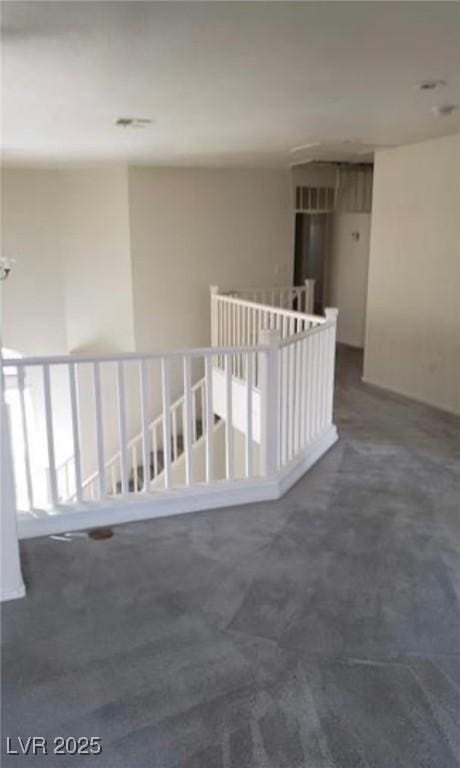 3644 Starlight Evening St, Las Vegas, NV 89129 - hallway with dark carpet and an upstairs landing