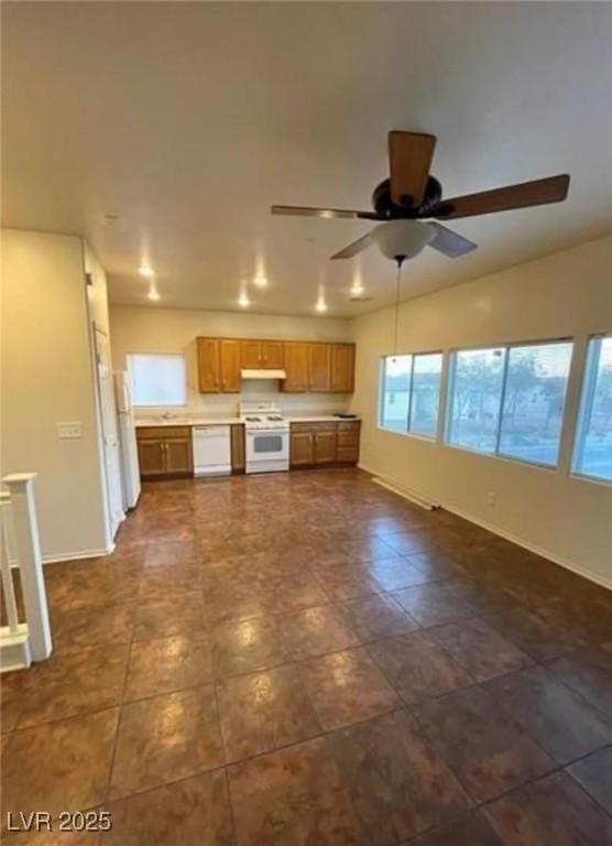 9402 Crimson Sky St, Las Vegas, NV 89178 - unfurnished living room featuring a ceiling fan and baseboards