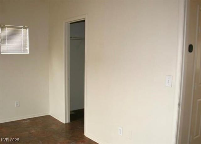 9402 Crimson Sky St, Las Vegas, NV 89178 - unfurnished bedroom featuring a walk in closet, baseboards, and a closet