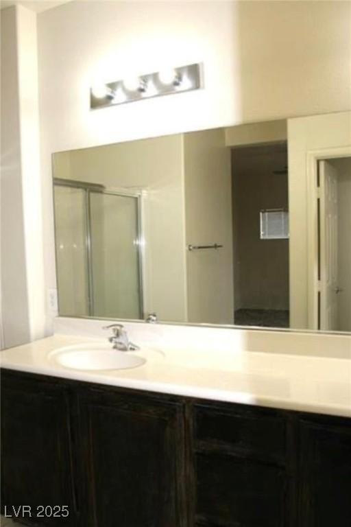 9402 Crimson Sky St, Las Vegas, NV 89178 - bathroom with double vanity and a shower with door