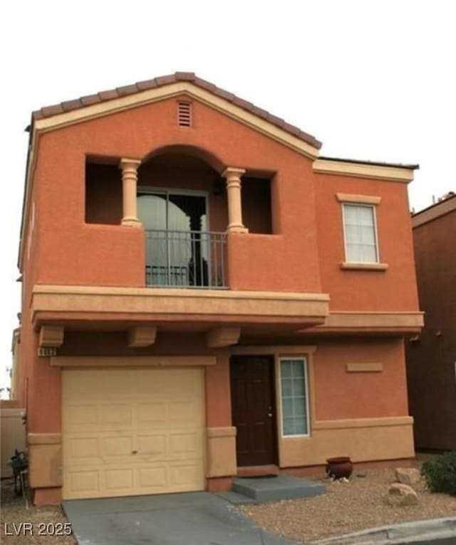 9402 Crimson Sky St, Las Vegas, NV 89178 - view of front facade featuring a balcony, stucco siding, an attached garage, and concrete driveway