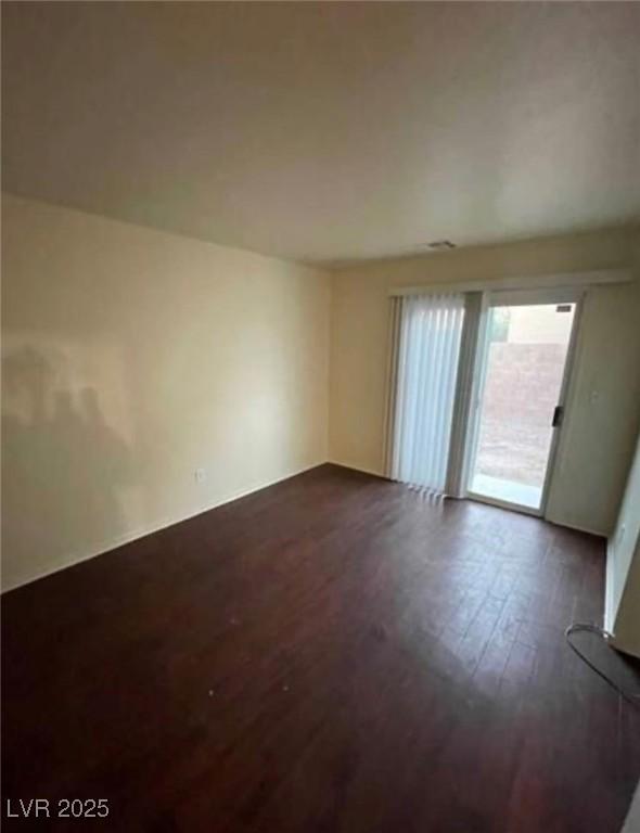 9402 Crimson Sky St, Las Vegas, NV 89178 - empty room with dark wood-style flooring