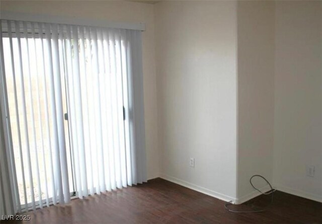 9402 Crimson Sky St, Las Vegas, NV 89178 - spare room featuring dark wood-style floors and baseboards