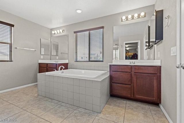8925 Kenzie Cove St, Las Vegas, NV 89131 - full bathroom with a bath, two vanities, tile patterned floors, and baseboards