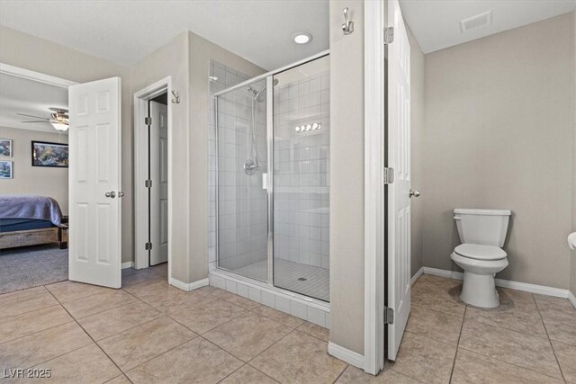 8925 Kenzie Cove St, Las Vegas, NV 89131 - ensuite bathroom featuring a stall shower, toilet, tile patterned flooring, and ceiling fan