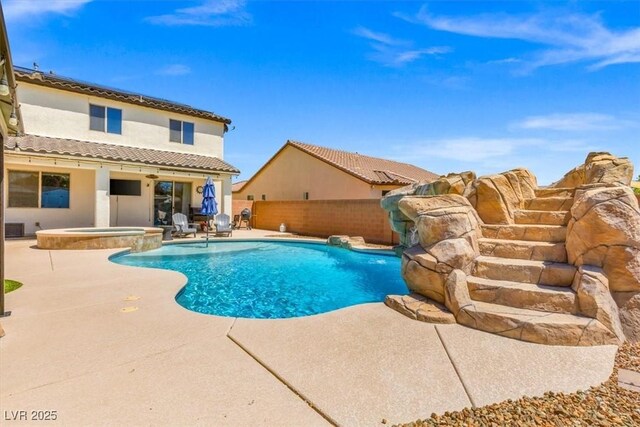 8925 Kenzie Cove St, Las Vegas, NV 89131 - view of swimming pool with a patio, a fenced backyard, and a pool with connected hot tub