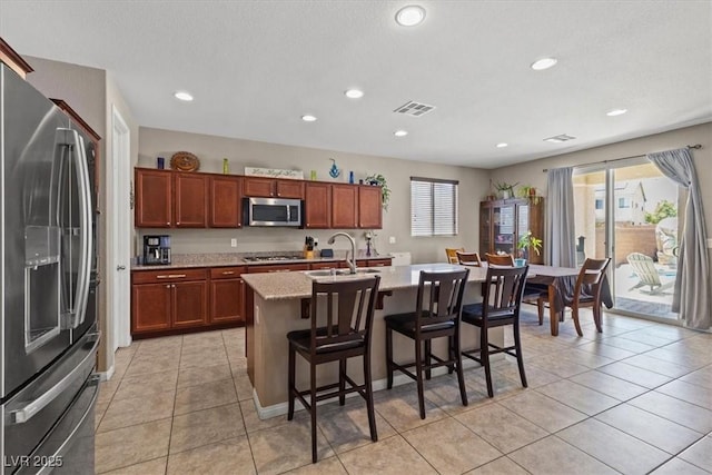 8925 Kenzie Cove St, Las Vegas, NV 89131 - kitchen featuring stainless steel appliances, a sink, plenty of natural light, a breakfast bar, and recessed lighting