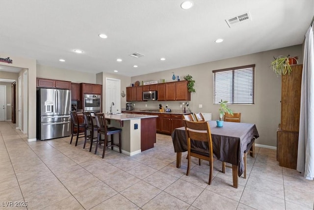 8925 Kenzie Cove St, Las Vegas, NV 89131 - kitchen featuring appliances with stainless steel finishes, recessed lighting, a kitchen island with sink, light countertops, and light tile patterned flooring