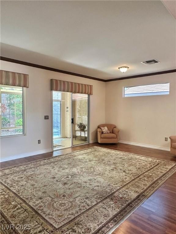 2138 Grand Traverse St, Henderson, NV 89052 - sitting room featuring wood finished floors, baseboards, and crown molding