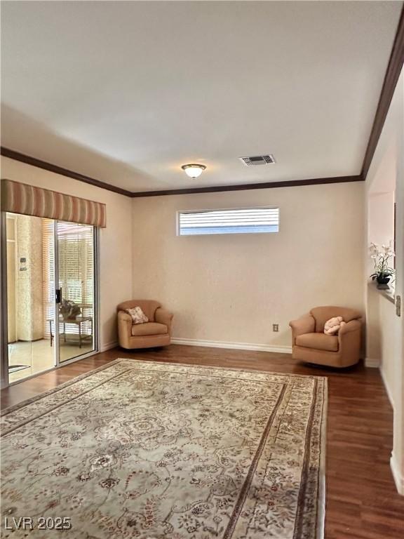 2138 Grand Traverse St, Henderson, NV 89052 - sitting room with wood finished floors, crown molding, and baseboards
