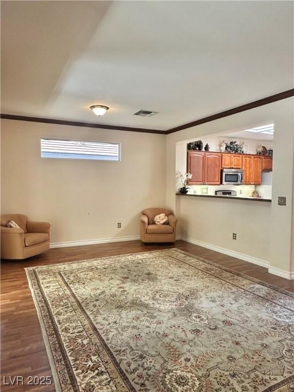 2138 Grand Traverse St, Henderson, NV 89052 - unfurnished living room featuring dark wood-style flooring, ornamental molding, and baseboards